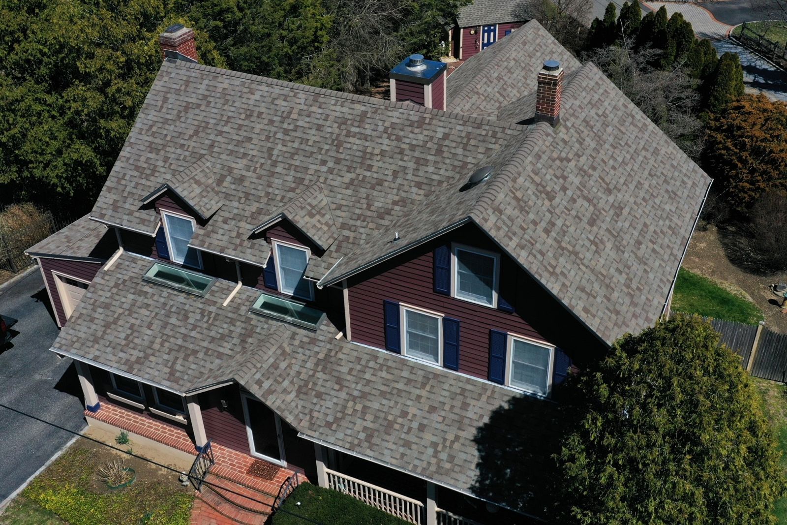Close up of a Allsite Roofing LLC worker installing new Shingle roof