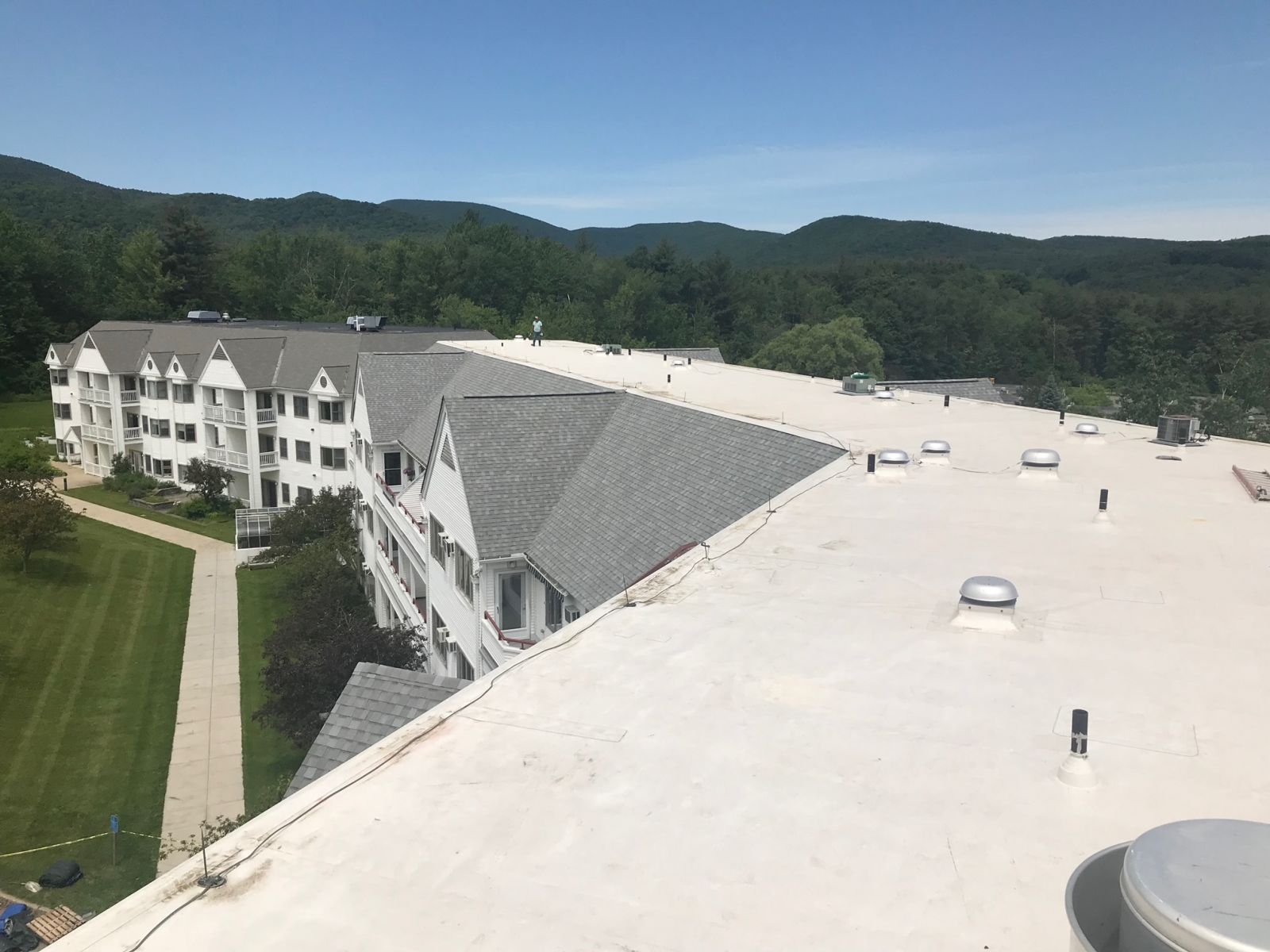 Close up of a Allsite Roofing LLC worker installing new White Membrane roof