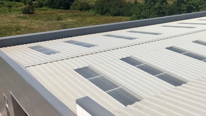 Close up of a Allsite Roofing LLC worker installing new Commercial Metal roof